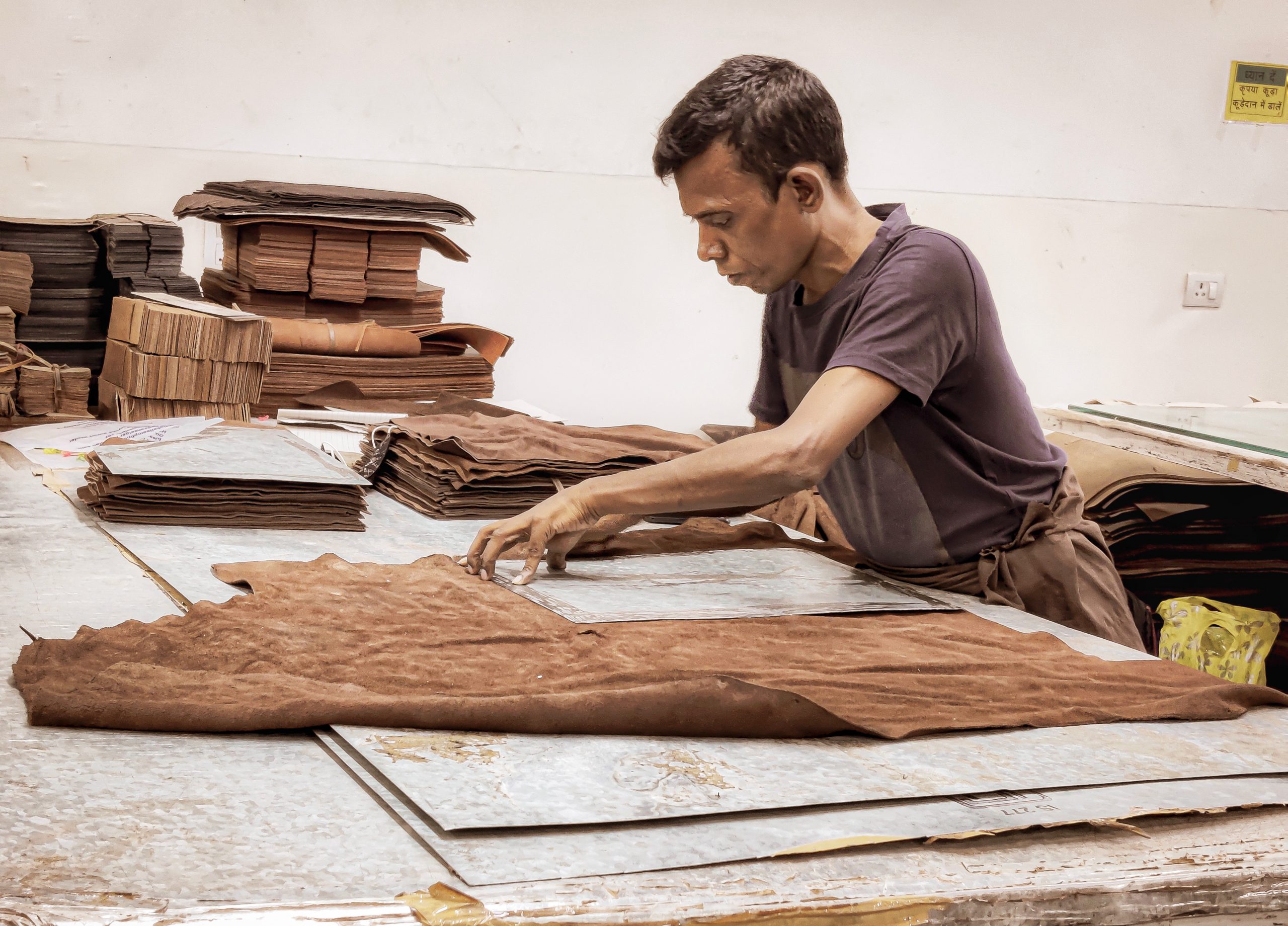 Artisan working on leather sheet